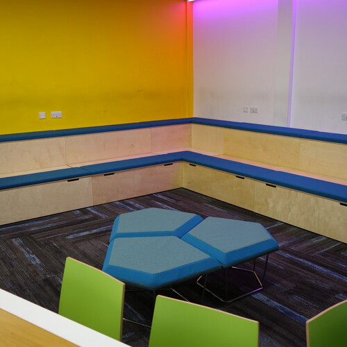 Barton Peveril College breakout area with upholstered bench seating and connection platforms